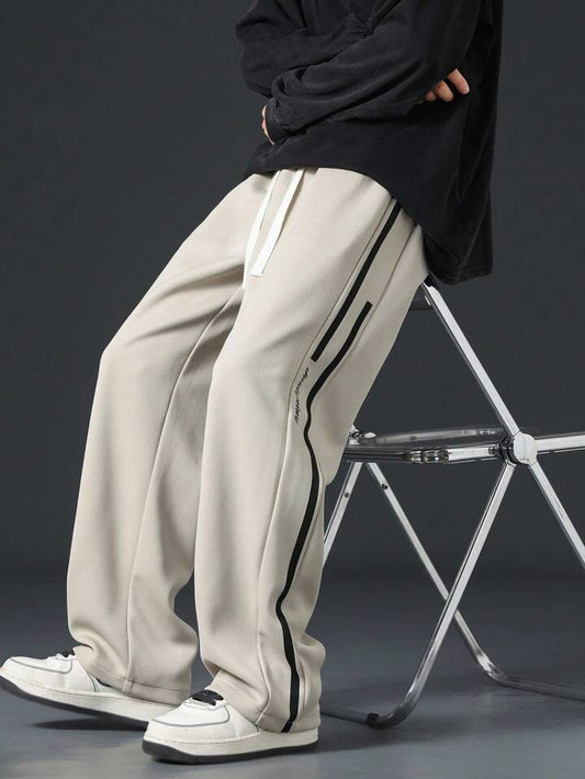 Beige straight fit track pants with narrow black side stripes, premium breathable all-season fabric by BombyyClothing