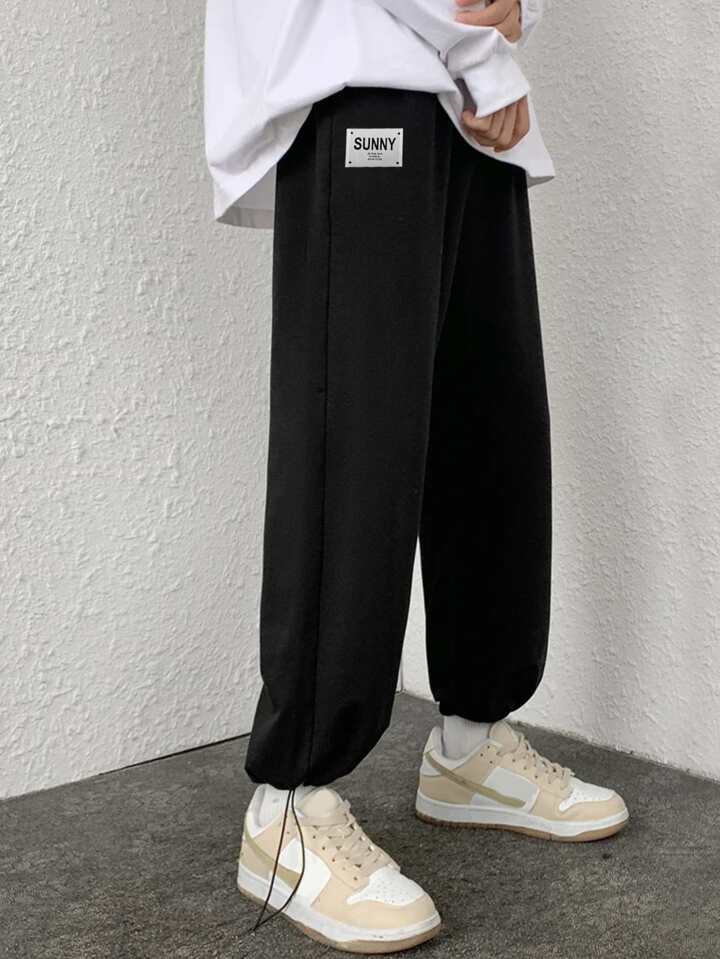 Black relaxed fit track pants with loose comfortable fit, premium breathable all-season fabric by BombyyClothing