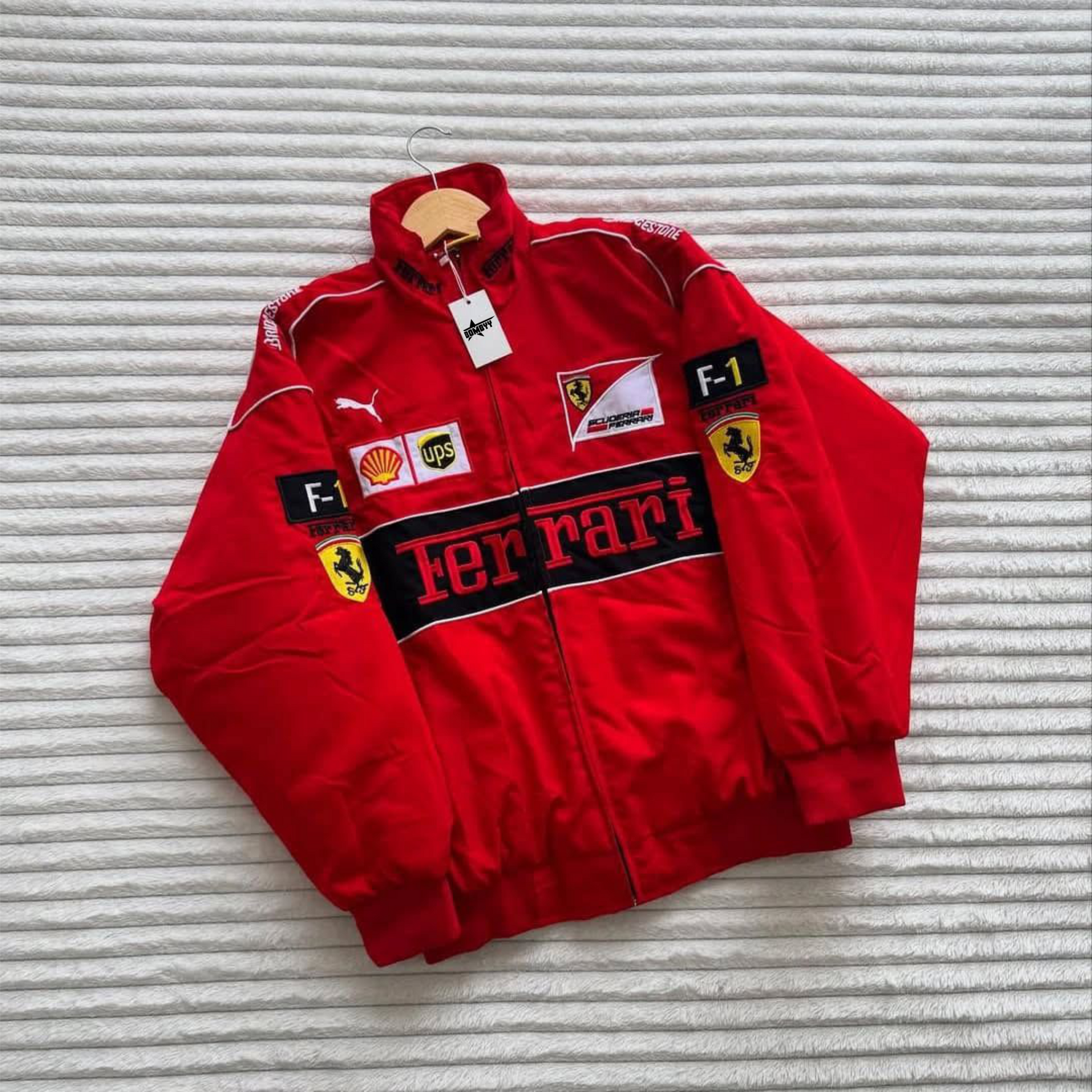 Vintage-style Ferrari Formula One bomber jacket featuring stitched embroidery and lightweight parachute fabric.