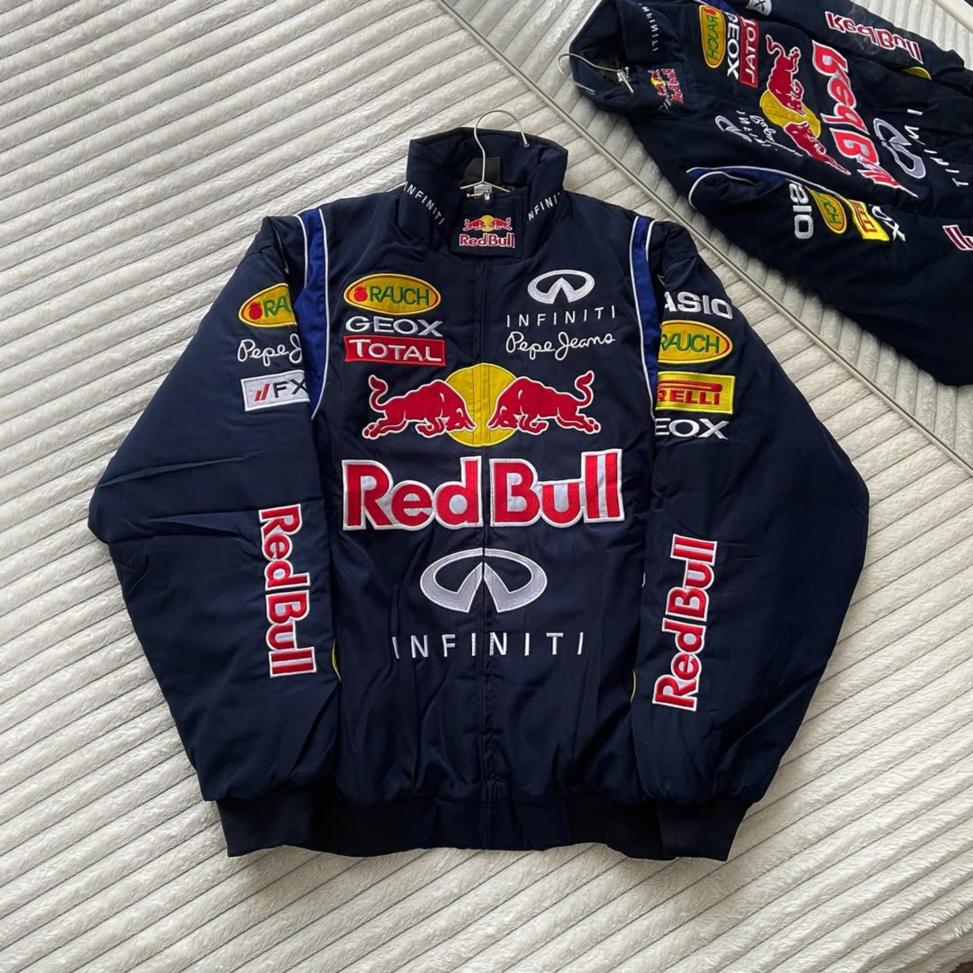 Black Red Bull Formula 1 puffer jacket with stylish logo embroidery, perfect for bikers and racing fans.